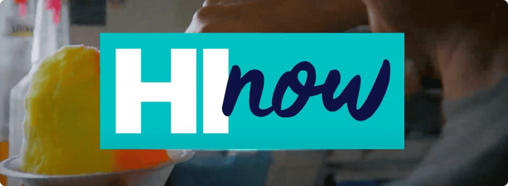 A person scoops bright yellow shaved ice into a cup. Overlaying the image is a blue and teal rectangular logo with the text "HI now," where "HI" is in white block letters and "now" is in a cursive style.